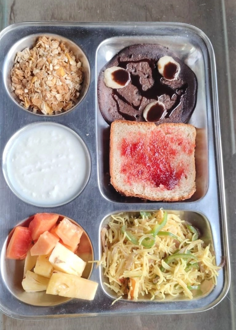 A healthy breakfast of fruit, curd and toast at Tattvaa Yogashala