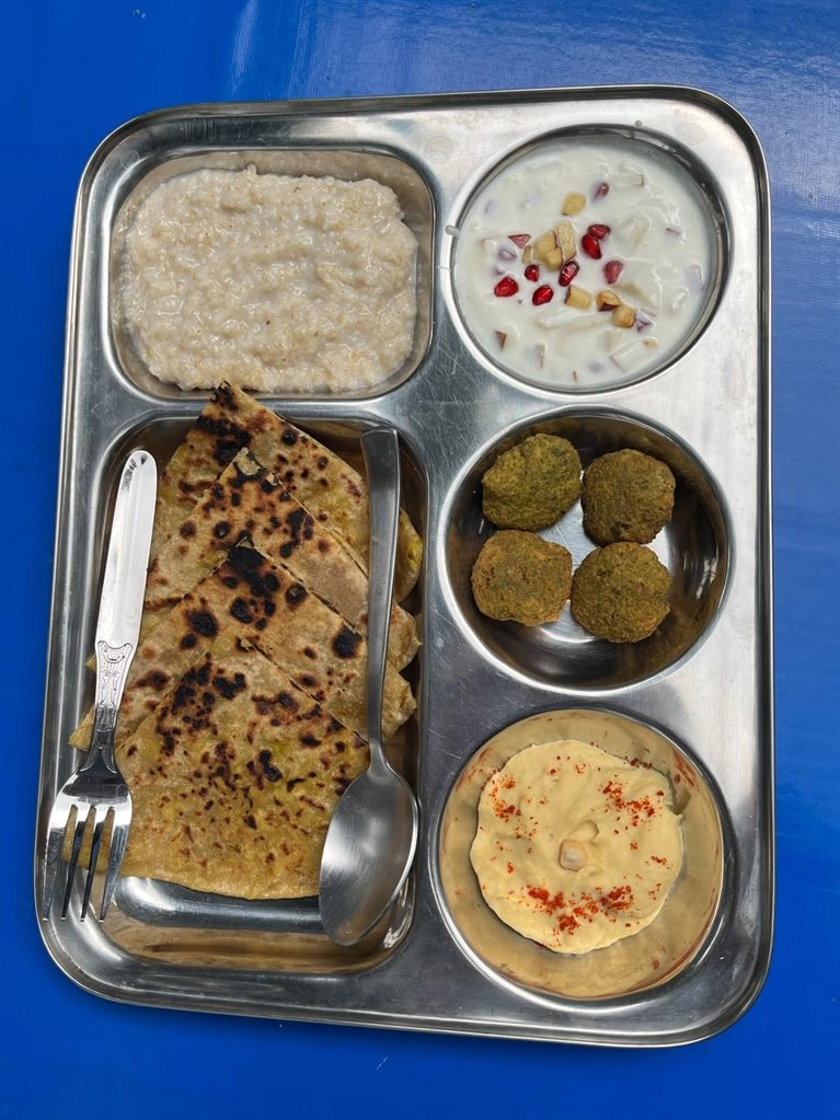 A paratha thali with sattvic sides at Tattvaa Yogashala