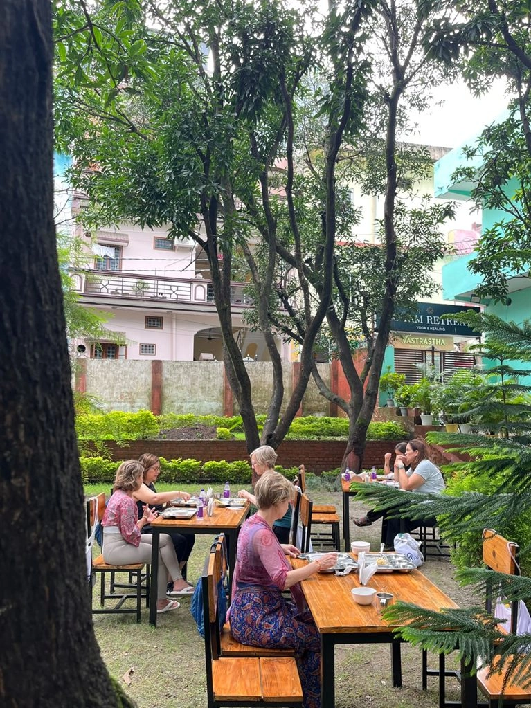 A meal under the trees in the ashram garden at Tattvaa Yogashala