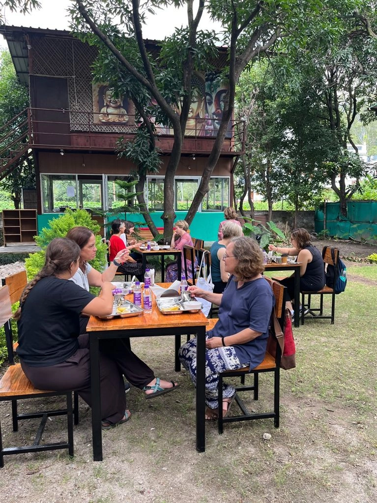 Students eating together in the garden at Tattvaa Yogashala