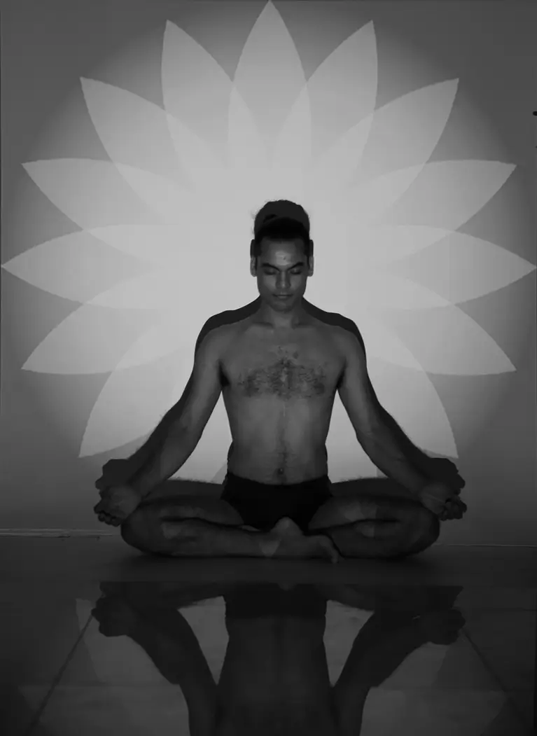 A yogi seated in meditation before a painted lotus
