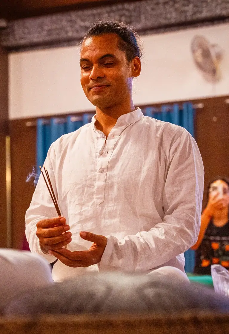 A teacher guiding a student through a posture