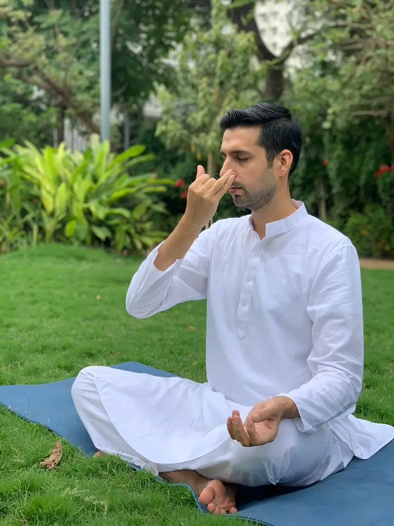 A teacher seated in pranayama practice