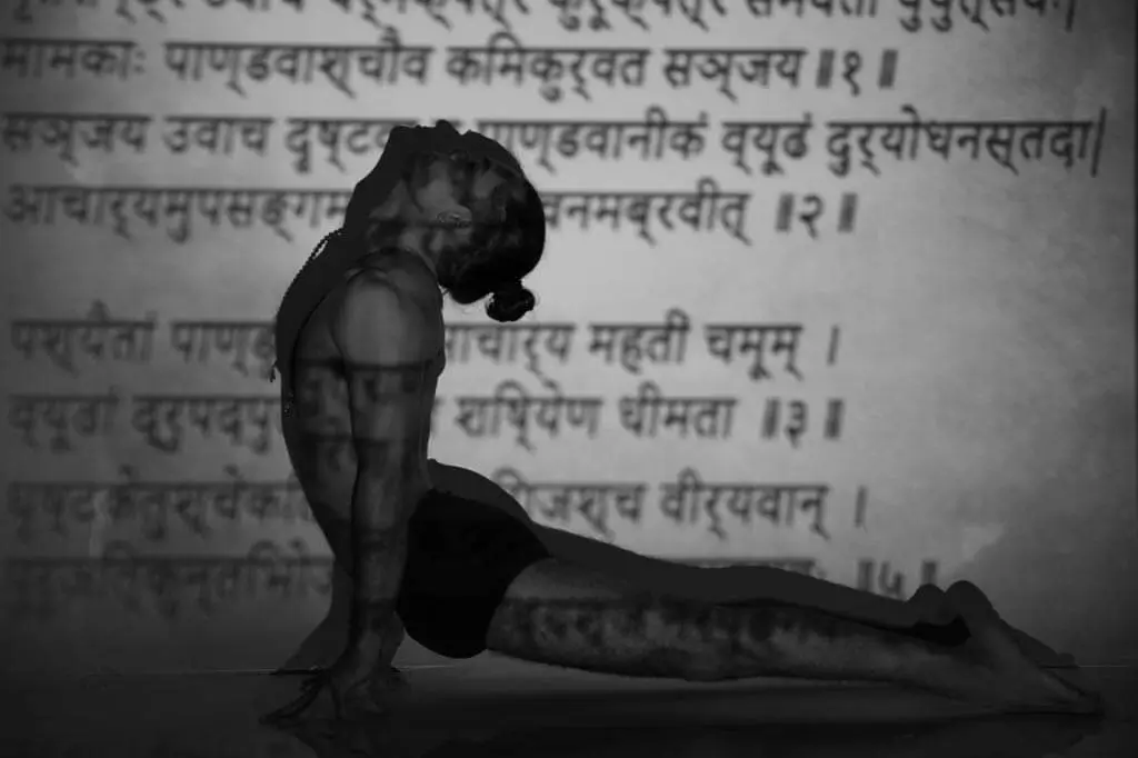 A student in cobra pose before a page of the Bhagavad Gita, double-exposed